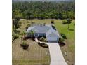 Stunning single-Gathering home featuring beautiful landscaping, a spacious driveway, and an attached two-car garage at 1025 Boundary Blvd, Rotonda West, FL 33947