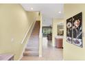 Welcoming entryway featuring a staircase, tile flooring, and a glimpse into the living room at 1215 Jonah Dr, North Port, FL 34289