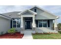 Charming front entrance features stone accents, pillars and detailed trim work at 13236 Pace Cir, Port Charlotte, FL 33981