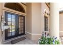 Inviting front entrance with double doors, beautiful tile, and a 'Welcome' mat for guests at 1367 Grebe Dr, Punta Gorda, FL 33950