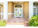 Elegant entryway with tiled porch and decorative glass double doors framed by stately pillars at 1374 Grebe Dr, Punta Gorda, FL 33950