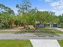 Charming exterior view of a single-story home with mature trees and a well-kept lawn at 1510 Orlando Blvd, Port Charlotte, FL 33952