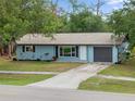 Inviting single-story home with well-maintained landscaping, a driveway, and an attached garage at 1510 Orlando Blvd, Port Charlotte, FL 33952