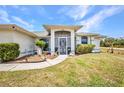 The home's entrance features a secure screen door and a beautifully landscaped pathway, leading to a cozy and secure welcome at 17210 Chase Ave, Port Charlotte, FL 33948