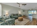 Inviting living room with neutral paint, ceiling fan, plush seating, and wood-look floors throughout at 20238 Banner Ave, Port Charlotte, FL 33952