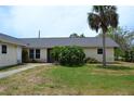 Single story home with a lawn at 21161 Knollwood Ave, Port Charlotte, FL 33952