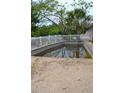 Backyard view of pool with a white fence at 21161 Knollwood Ave, Port Charlotte, FL 33952