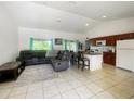 Open-concept living room and kitchen area, with modern tile flooring and plenty of natural light at 2336 Redfern St, Port Charlotte, FL 33948
