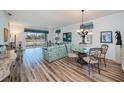 Bright living room with hardwood floors, stylish dining area, and large windows offering scenic views at 25511 Heritage Lake Blvd # 8, Punta Gorda, FL 33983