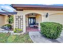 Inviting front porch with tiled entrance and decorative trellis feature at 3663 Sterling Rd, Venice, FL 34293