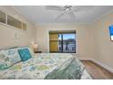 Cozy bedroom featuring a ceiling fan, neutral carpet, and a window view to the outdoors at 474 Lomond Dr, Port Charlotte, FL 33953