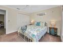 Comfortable bedroom with carpeted floors, ceiling fan, and closet space at 474 Lomond Dr, Port Charlotte, FL 33953