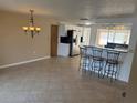 Open concept dining and kitchen area with tile floors, breakfast bar, and stainless steel appliances at 635 W Tarpon Nw Blvd, Port Charlotte, FL 33952