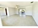 Bright living room with terrazzo flooring and access to the screened porch at 700 Dolphin Pkwy, Punta Gorda, FL 33950