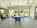 Enclosed porch featuring tiled floor, ceiling fans, and lawn views at 700 Dolphin Pkwy, Punta Gorda, FL 33950