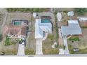 Aerial view of a home with a screened-in pool, well-maintained yard, and a modern metal roof at 7333 Watson Ln, Port Charlotte, FL 33981