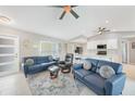 Spacious living room with comfortable seating, neutral decor, and an open layout to the kitchen at 7333 Watson Ln, Port Charlotte, FL 33981