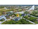 Aerial shot showcasing the waterfront property and neighborhood with canal access at 9239 Impala Cir, Port Charlotte, FL 33981