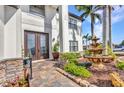 Close up of an inviting home entrance, featuring double doors and decorative stone accents at 9239 Impala Cir, Port Charlotte, FL 33981