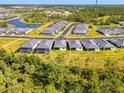 Aerial view showcasing the property's location within the community, near a pond and lush landscaping at 10995 Pinot Dr, Venice, FL 34293
