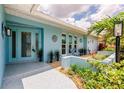 Beautiful home front porch with tropical landscaping, tiled walkway and charming decorations at 12596 Bacchus Rd, Port Charlotte, FL 33981