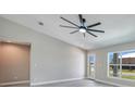 Spacious living room featuring wood-look tile flooring, high ceilings, and lots of natural light at 13972 Chesswood Ln, Port Charlotte, FL 33981