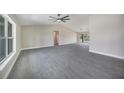 Open floor plan showcasing the living room's tile floors, high ceilings, and bright, airy atmosphere at 13972 Chesswood Ln, Port Charlotte, FL 33981