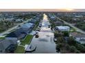 Aerial view of waterfront homes lining the canal at sunset at 15504 Melport Cir, Port Charlotte, FL 33981
