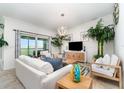 Bright living room featuring tile floors, comfortable seating, and sliding glass doors to the balcony at 15990 Grassland Ln # 3024, Punta Gorda, FL 33982