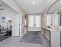 Welcoming foyer featuring decorative mirror, elegant decor, and a view of the living spaces at 17924 Corkwood Bend Trl, Punta Gorda, FL 33982