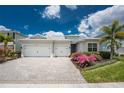 Charming one-story home featuring a two-car garage, lovely landscaping, and a brick paved driveway at 17924 Corkwood Bend Trl, Punta Gorda, FL 33982
