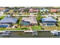 Aerial view of waterfront home featuring a private dock and screened-in pool area at 2100 Via Esplanade, Punta Gorda, FL 33950