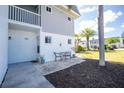 Charming patio area with outdoor seating, a well-manicured lawn, and palm trees for a relaxing outdoor experience at 22375 Edgewater Dr # 123, Punta Gorda, FL 33980