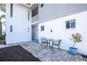 Cozy patio with brick pavers, an outdoor seating set, and vibrant potted plants enhancing the outdoor living space at 22375 Edgewater Dr # 123, Punta Gorda, FL 33980