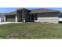 Charming single-story home featuring a well-maintained lawn and welcoming entrance at 2250 Homestead Cir, North Port, FL 34286