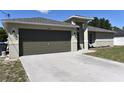 Close-up of a single-story home showing a two car garage and neutral colored paint at 2250 Homestead Cir, North Port, FL 34286