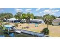 Spacious waterfront backyard with a screened pool, boat dock, and lush landscaping at 2331 Cannolot Blvd, Port Charlotte, FL 33948