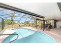 Screened-in pool area with lounge chairs, grill, and covered patio for outdoor relaxation at 2331 Cannolot Blvd, Port Charlotte, FL 33948