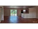 Open-concept living area with a view of the kitchen and access to the backyard at 2585 Yuma Ave, North Port, FL 34286