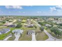 Expansive aerial view of a residential neighborhood showcasing lush greenery and well-spaced single-Gathering homes at 27306 Deep Creek Blvd, Punta Gorda, FL 33983