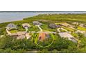 Aerial view of a home with a screened-in pool in a scenic waterside community at 3050 Rivershore Ln, Port Charlotte, FL 33953
