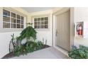 Charming front entry features a neutral door and lovely landscaping, creating a warm welcome at 3412 Grand Vista Ct # 202, Port Charlotte, FL 33953