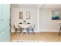 Cozy dining area featuring a white table with two chairs, with natural light and light blue door in view at 3502 N Lincoln Ave, Tampa, FL 33607