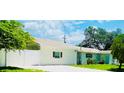 Single-story home featuring a privacy fence and landscaped yard at 3502 N Lincoln Ave, Tampa, FL 33607