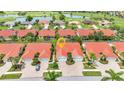 Aerial view of homes with red tiled roofs situated on a golf course with a pond at 3715 Albacete Cir # 93, Punta Gorda, FL 33950
