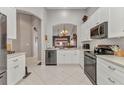 Bright kitchen featuring white cabinets, stainless steel appliances, and a seamless design at 3715 Albacete Cir # 93, Punta Gorda, FL 33950