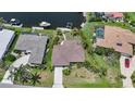 Aerial view of property with a boat dock and lift on the water at 376 Portofino Dr, Punta Gorda, FL 33950