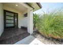 Tiled front entrance with landscaped plantings and a column at 376 Portofino Dr, Punta Gorda, FL 33950