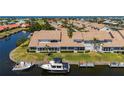 Rear exterior showing screened lanai and boat dockage on a canal at 3800 Bal Harbor Blvd # 415, Punta Gorda, FL 33950