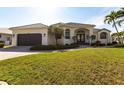 Well-maintained, single-story home featuring a two-car garage, manicured lawn, and arched entry at 3907 San Pietro Ct, Punta Gorda, FL 33950